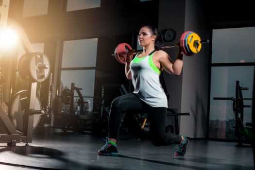fit-young-woman-lifting-barbells-looking-focused-working-out-gym_155003-5353